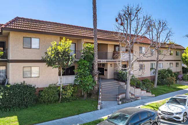 Mid-century apartment building with palm trees and landscaped entry